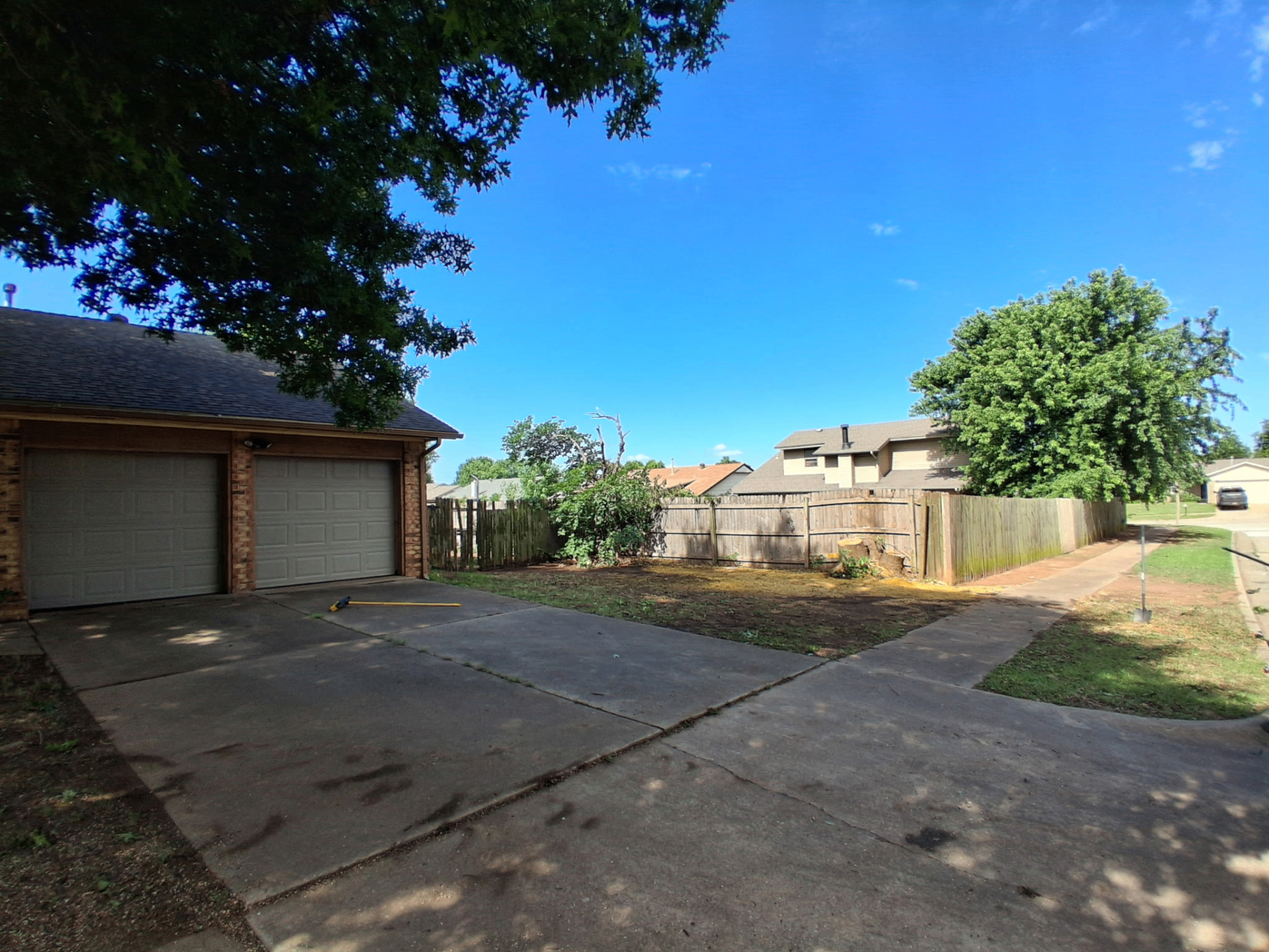 Front yard and driveway cleaned up after complete tree removal by Wild Axe Arborists