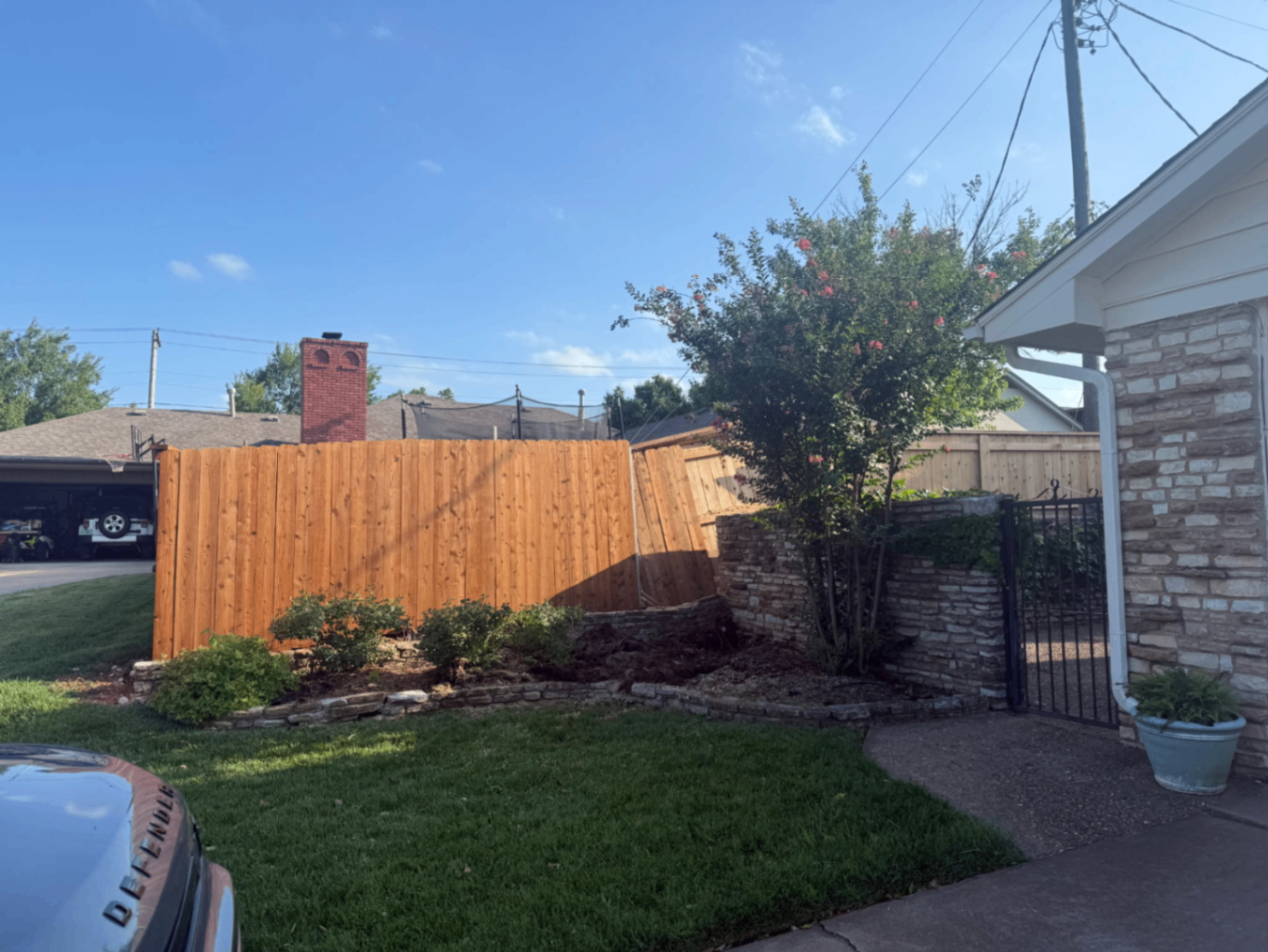 Second angle of the restored property after storm damage cleanup by Wild Axe Arborists